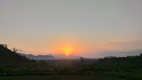 Scenic view of landscape against sky during sunset