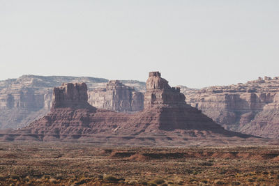 Rock formations on landscape against clear sky