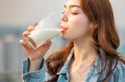 Portrait of beautiful woman drinking glass