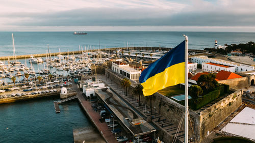 Ukrainian flag on cascais harbour, portugal to support ukraine during its war with russia