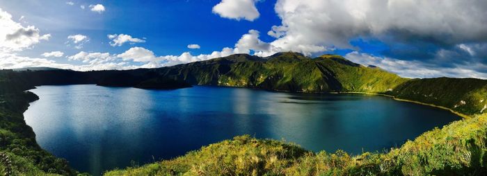 Panoramic view of lake and mountains against blue sky