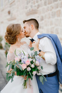 Midsection of woman holding flower bouquet