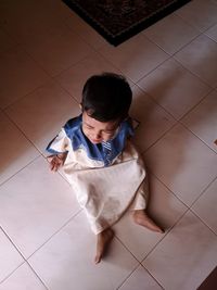 High angle view of boy on floor