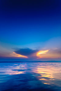 Scenic view of sea against sky at sunset