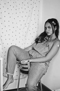 Portrait of young woman sitting on floor