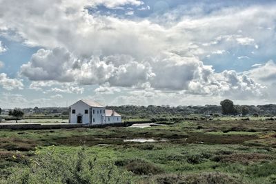 Houses on field against sky