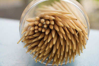 Close-up of toothpicks in container on table