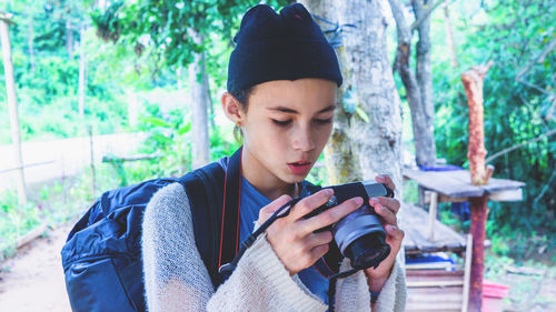 Pretty cute girl looking at photo in camera. vacation. thai teen idol.