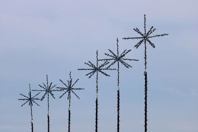 Low angle view of telephone pole against sky