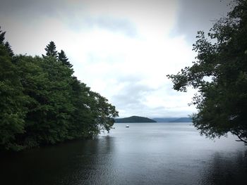 Scenic view of calm sea against cloudy sky