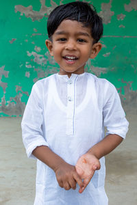 Portrait of smiling boy standing outdoors