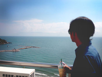 Portrait of man looking at sea against sky