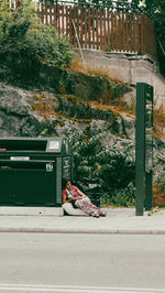 Man on road by street in city