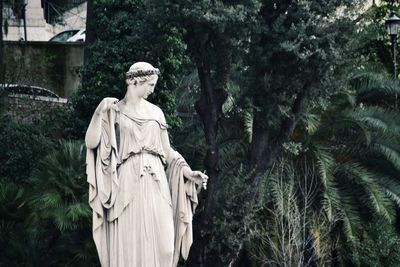 Statue against trees