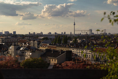 Cityscape against cloudy sky