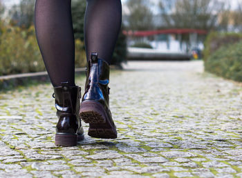 Low section of woman exercising on road
