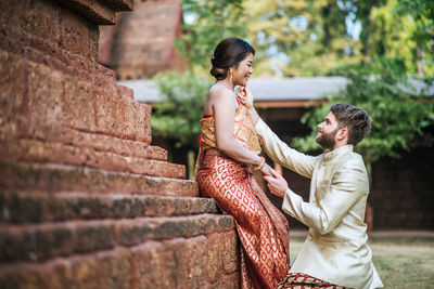 Side view of couple kissing outdoors