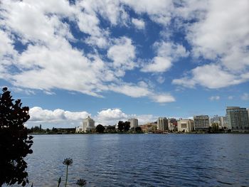 Scenic view of lake by buildings against sky