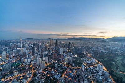 High angle view of city buildings against sky during sunset