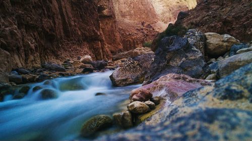 Scenic view of river flowing through rocks