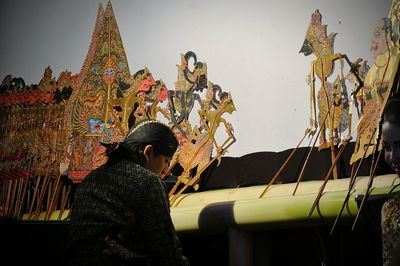 Low angle view of man standing at temple against sky