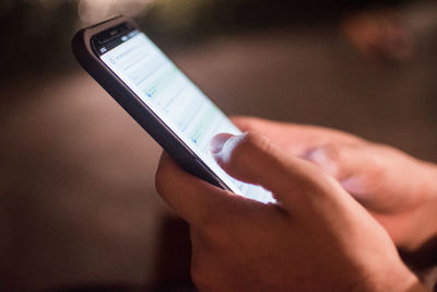 Midsection of person using mobile phone