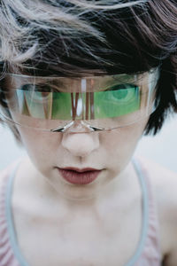 Androgynous woman with short hair wearing futuristic glasses