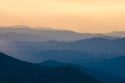 Scenic view of silhouette mountains against sky during sunset