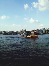 Boats in river with buildings in background