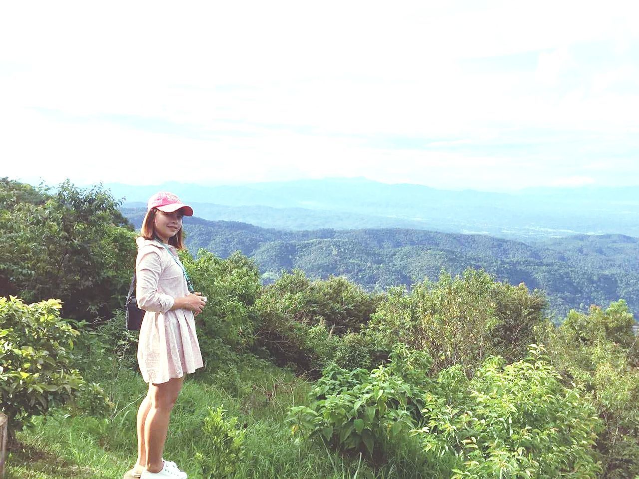 one person, nature, young adult, beauty in nature, casual clothing, standing, real people, day, leisure activity, outdoors, sky, tranquility, young women, scenics, tree, mountain, full length, landscape, plant, growth, clear sky, grass, adult, people