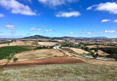 Scenic view of agricultural landscape against sky