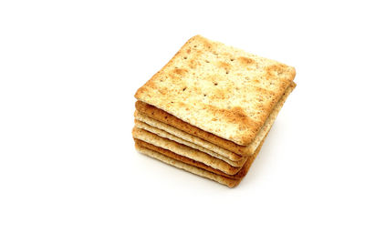 High angle view of bread in plate against white background