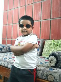 Full length of girl wearing sunglasses sitting outdoors