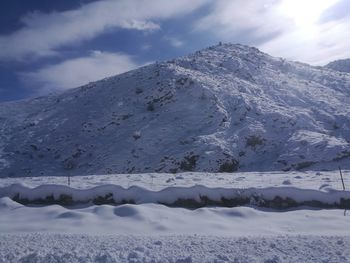 Scenic view of snowcapped mountains against sky