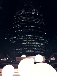 Low angle view of illuminated building against sky at night