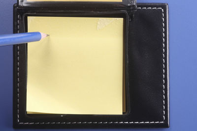 High angle view of black and blue paper on table