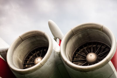 Low angle view of jet engine against sky