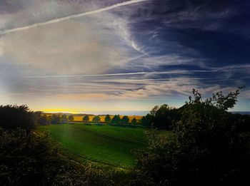 Scenic view of field against sky during sunset