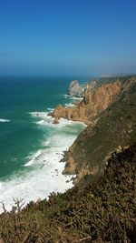 Scenic view of sea against clear blue sky