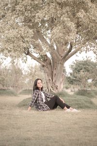 Portrait of woman sitting on field