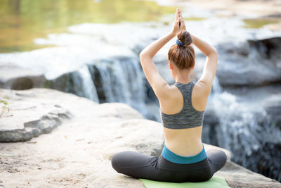 Rear view of woman sitting outdoors