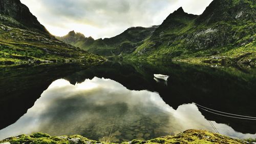 Scenic view of mountain range against cloudy sky