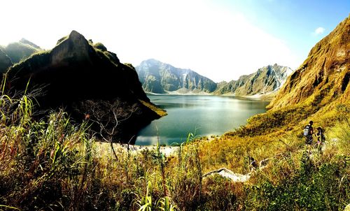 Scenic view of lake and mountains against sky