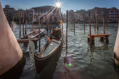 Boats in canal amidst buildings in city