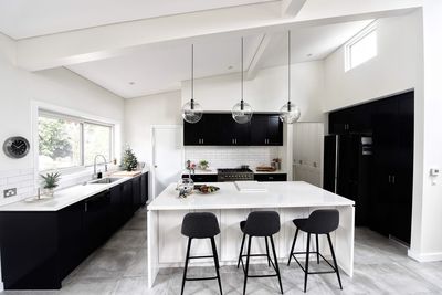 Empty chairs by kitchen island at home