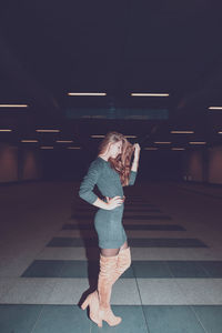 Full length of woman standing in underground walkway