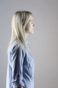 Side view of a woman against white background