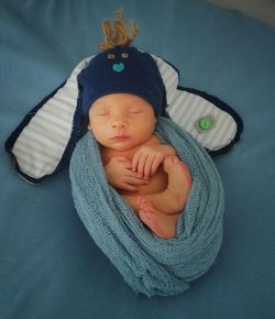 High angle view of newborn sleeping on bed