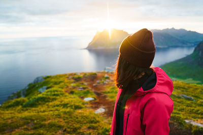 Rear view of woman looking at sea against sky