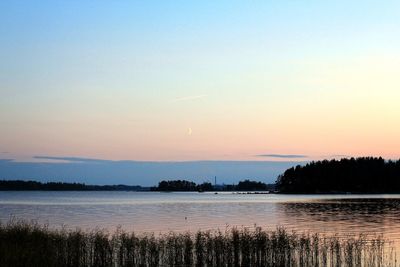 Scenic view of lake against romantic sky at sunset